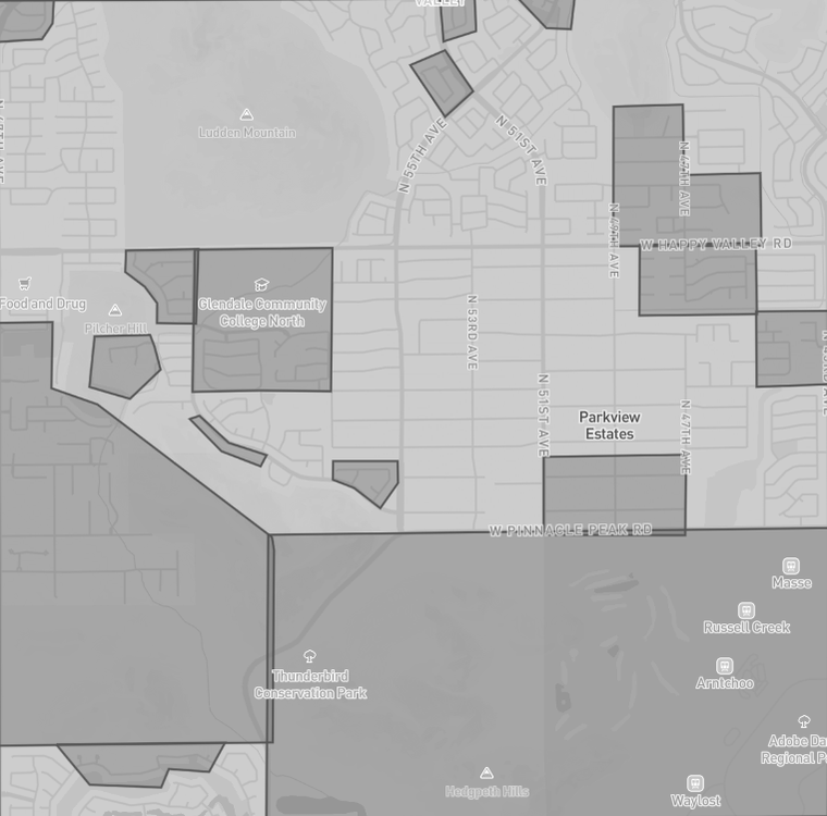 A grayscale street map of north Glendale with a large shaded territory and several white exclusion shapes drawn over parks, a college campus and neighborhoods.